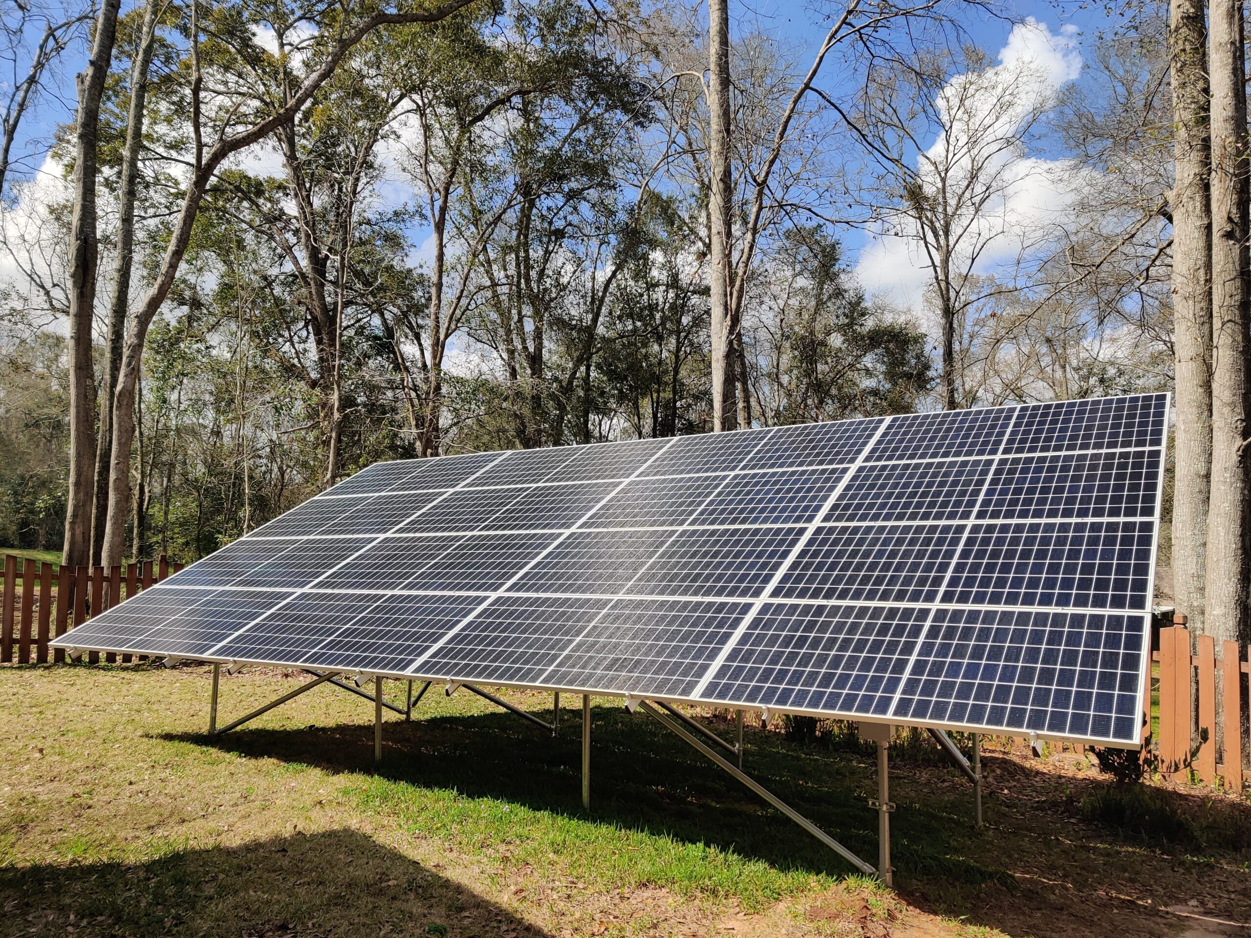 Ground mounted solar array with trees in the background