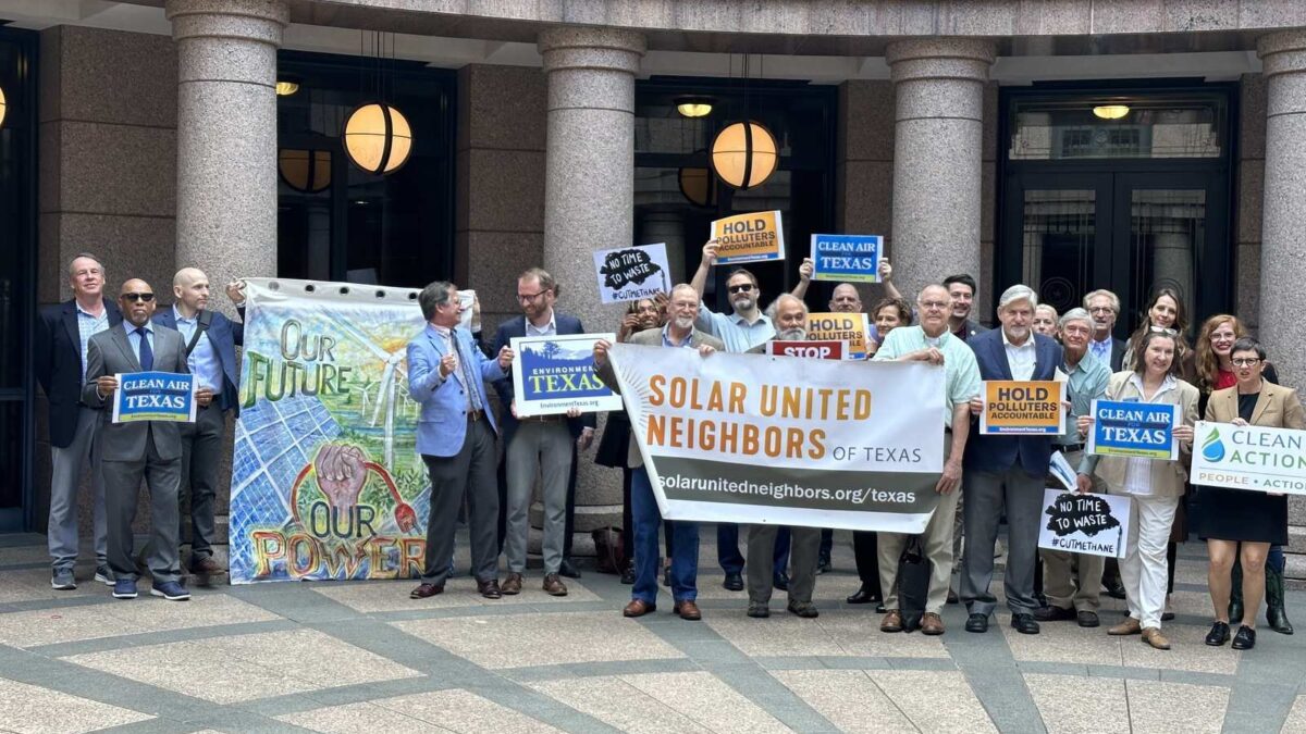 Group of people holding signs supporting clean air in Texas.