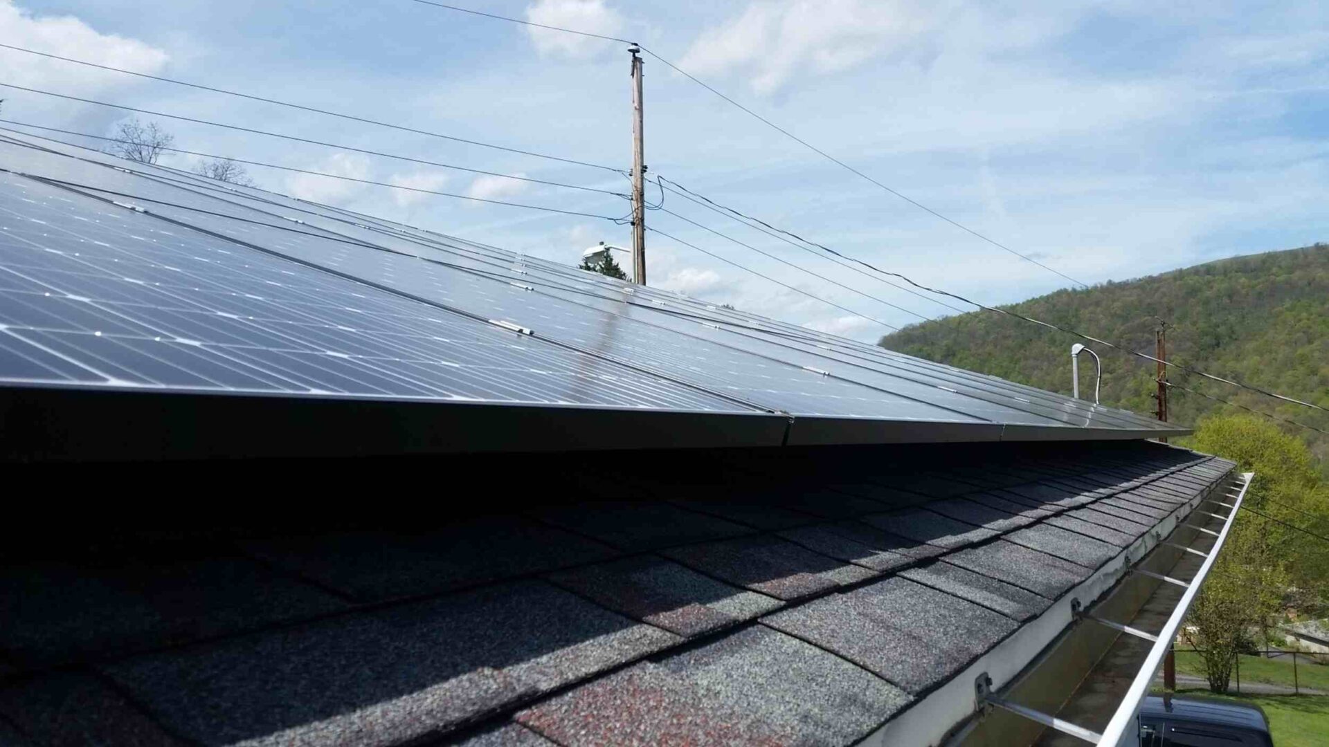 Solar panel on roof of house in a rural area.