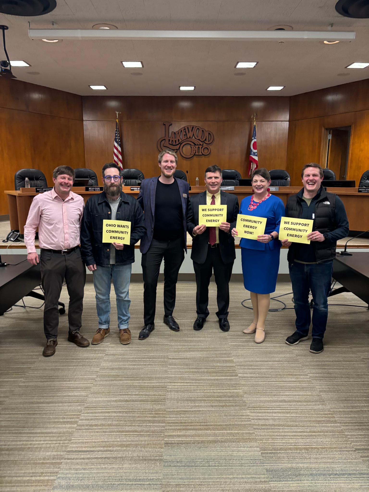Advocates holding community energy signs in a Lakewood, Ohio courtroom. 