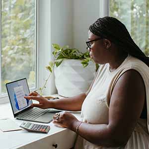 Woman on her computer working at home.