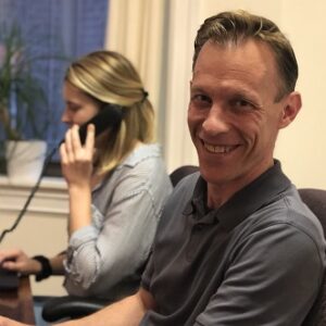 Man and woman sitting at a desk.