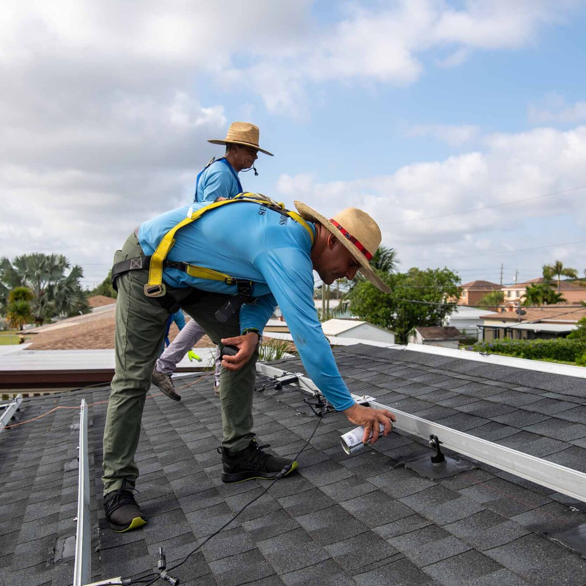 Installers working on solar panels.