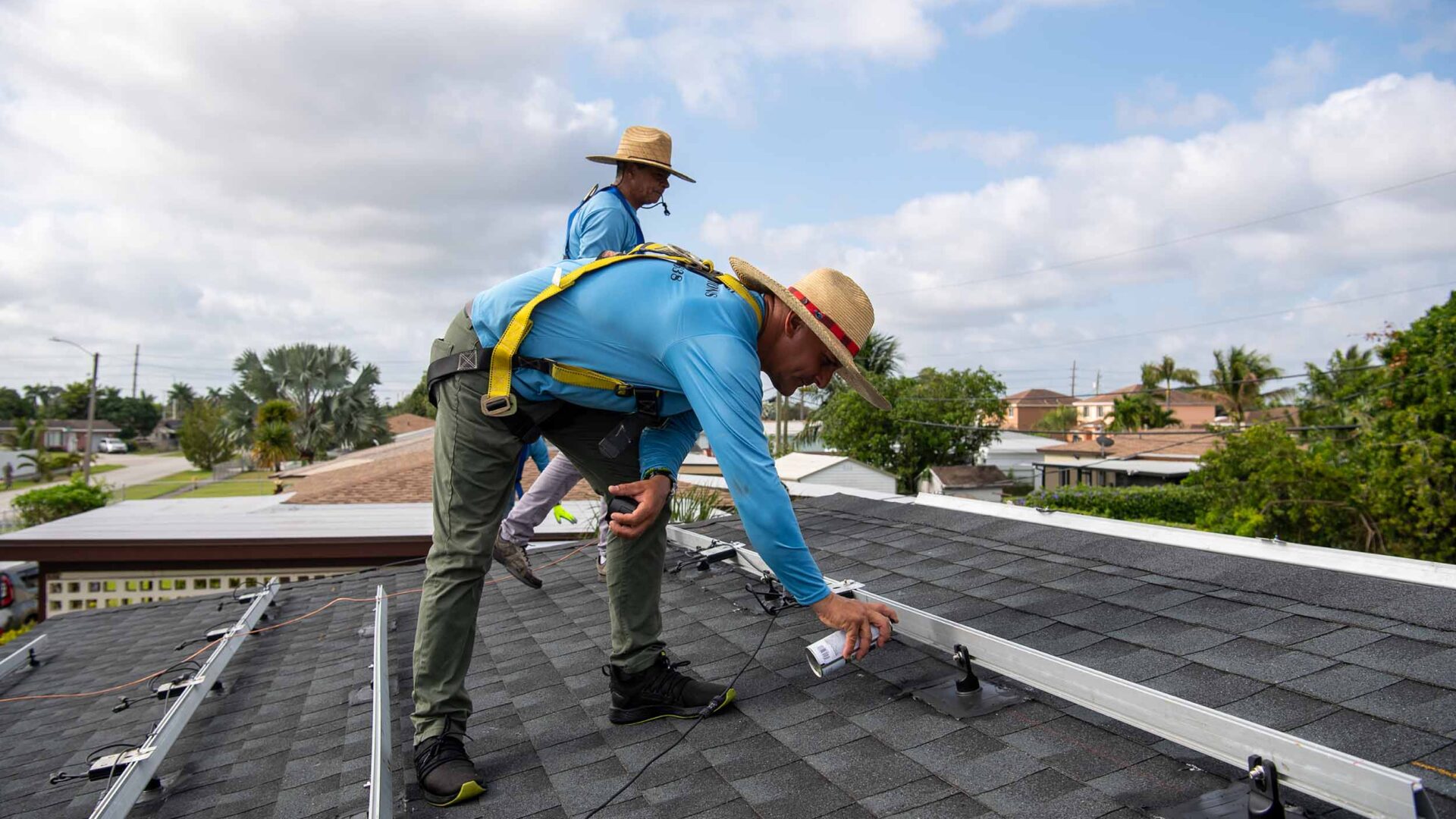 Installers working on solar panels.