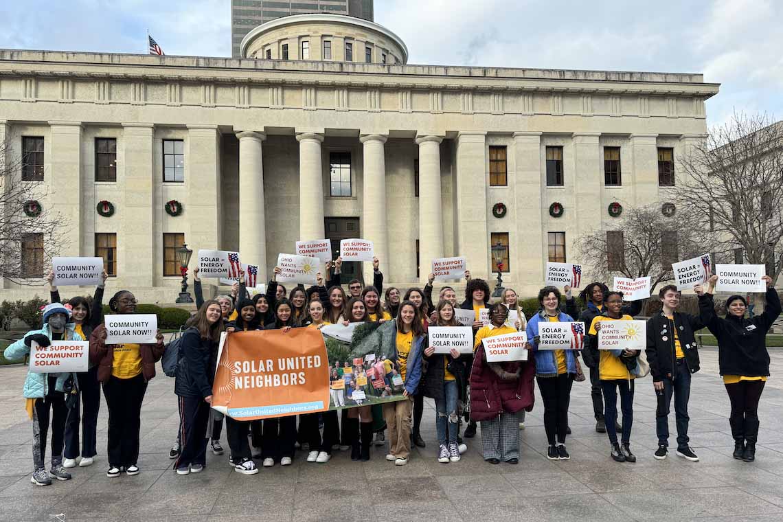 Group of solar advocates standing in front of a Capitol building.