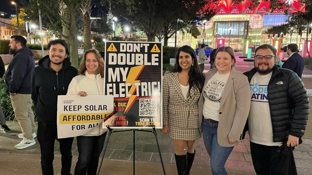 group of 5 people with poster reading don't double my electric