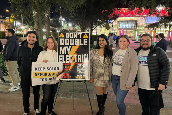 group of 5 people with poster reading don't double my electric
