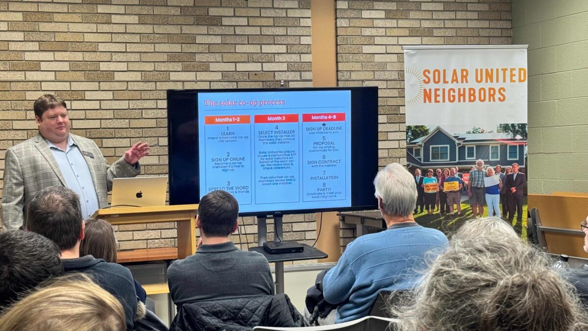 SUN staff presents Solar 101 in front of audience.