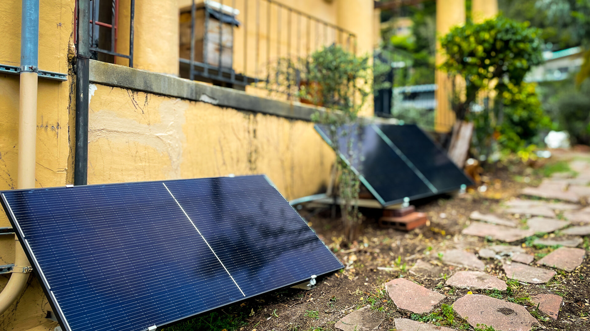two plug-in solar panels outside of a home