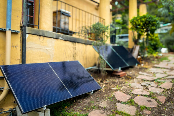 two plug-in solar panels outside of a home