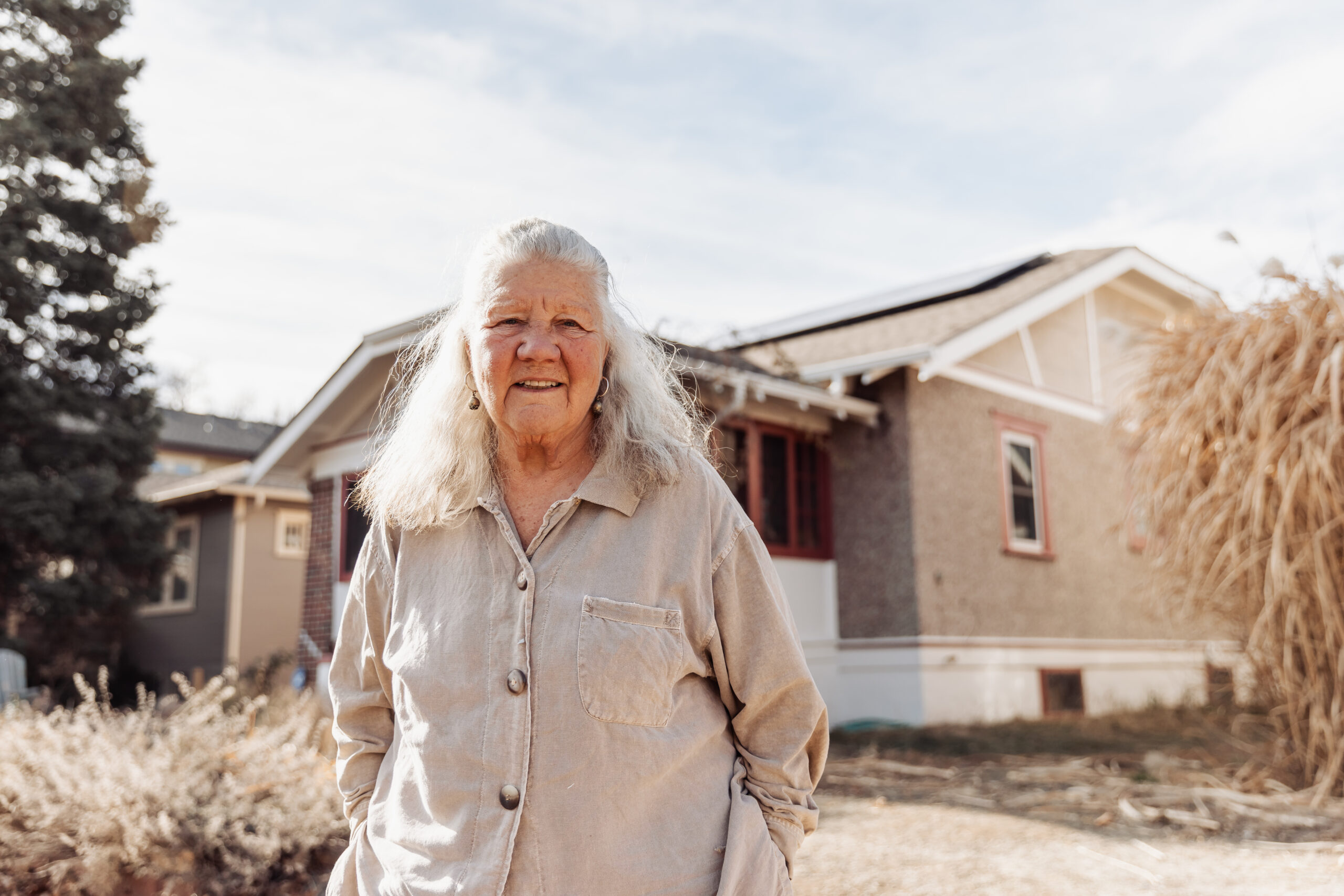 Shawna Crocker smiles in front of her solar home 
